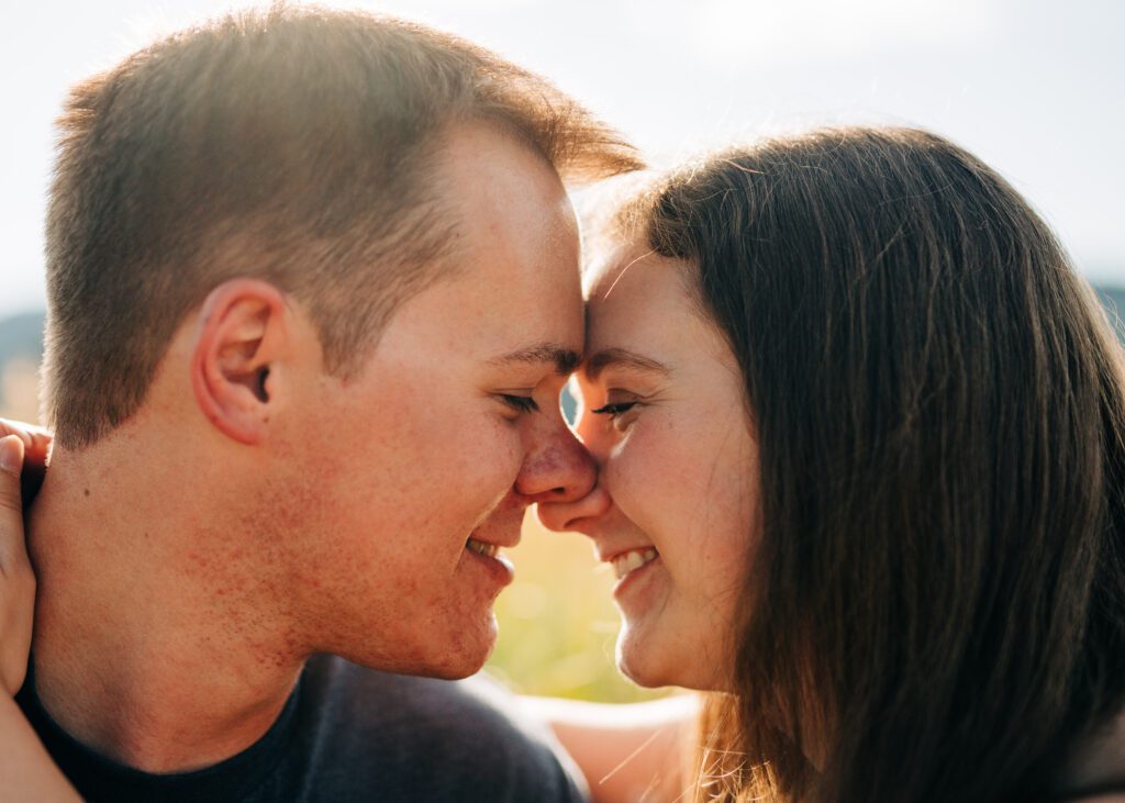 engaged couple smiling with their noses touching during their boulder colorado engagement session