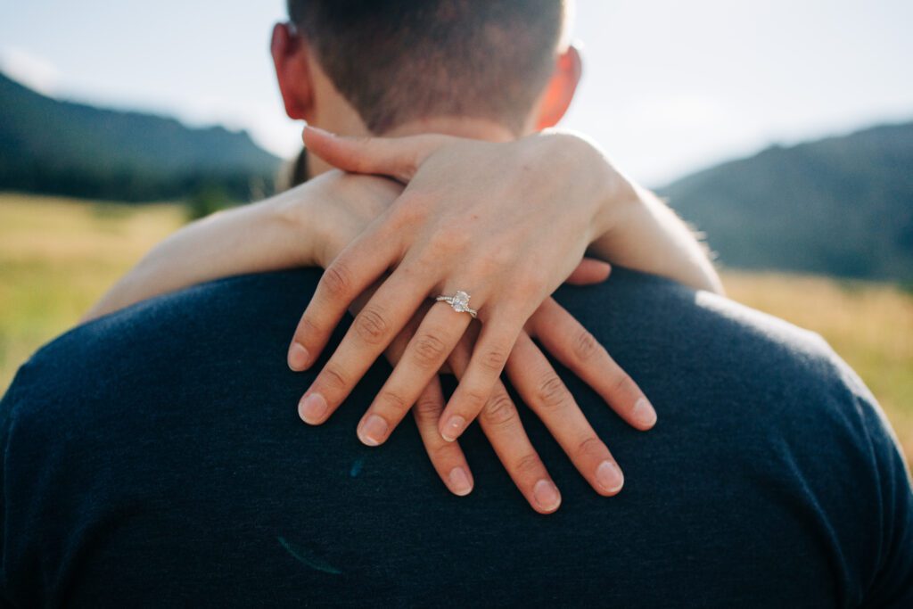 closeup of girl wearing her engagement ring during her and her fiance's boulder engagement photos