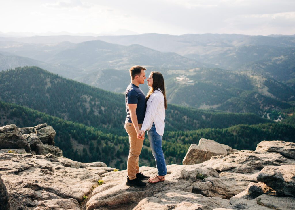 couple holding hands and smiling at eachother at lost gulch overlook in boulder colorado during their boulder engagement session