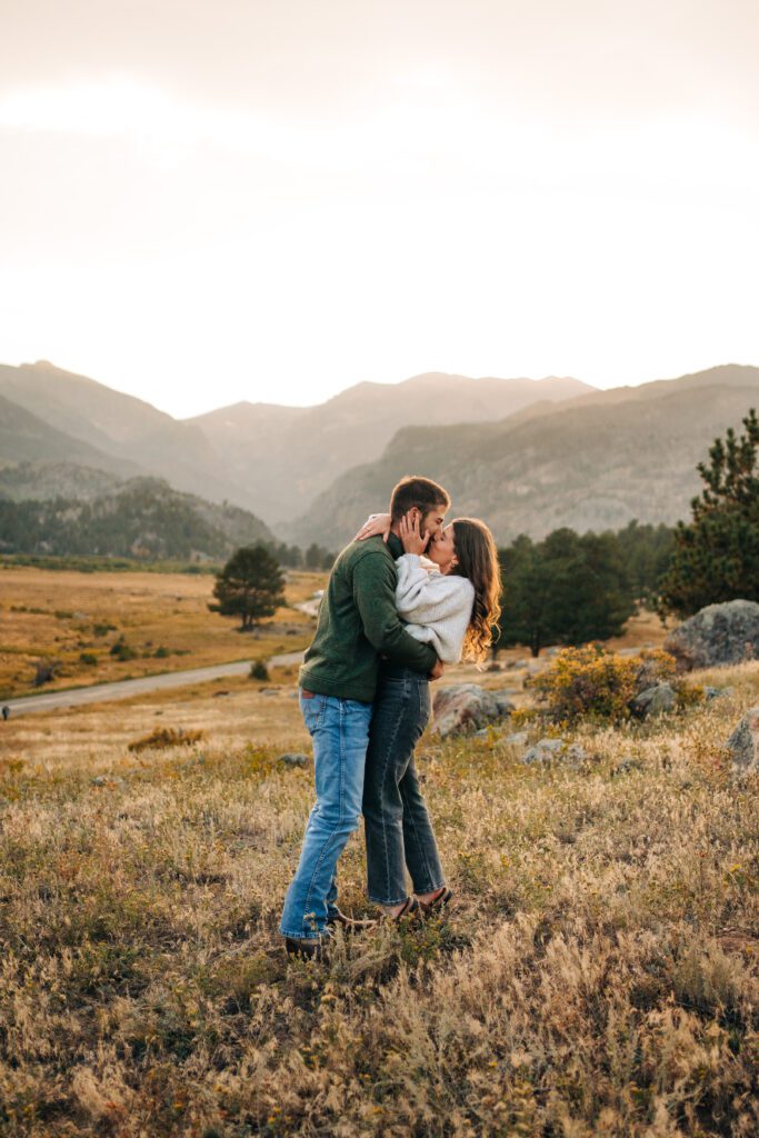 Boyfriend kissing his girlfriend after he proposed to her in Moraine Park at sunset in Rocky Mountain National Park Colorado