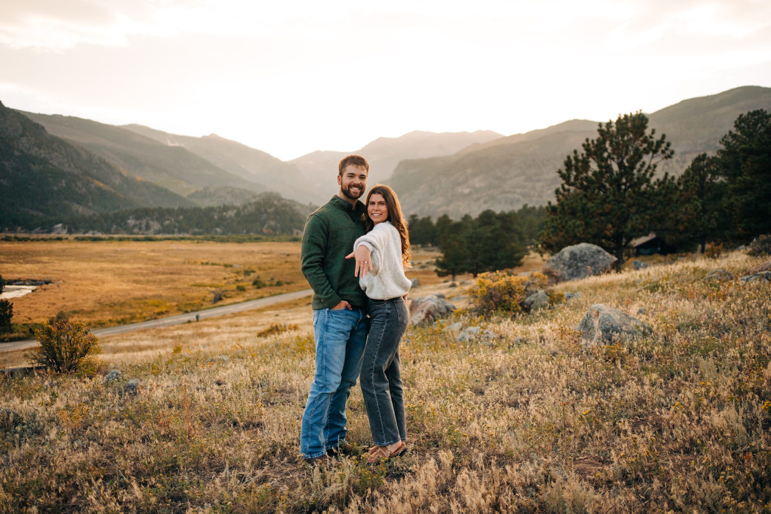 Girl showing off her new engagement ring after her boyfriend proposed to her at sunset at Moraine Park in Rocky Mountain National Park Colorado