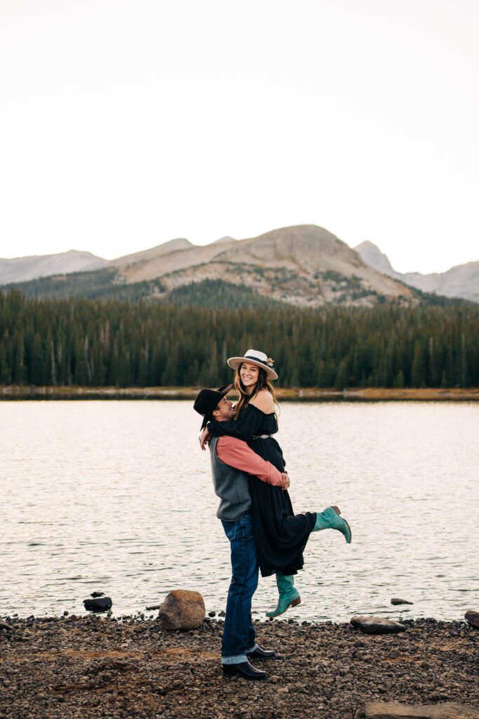 Boyfriend lifting his girlfriend up in the air during their Brainard Lake Engagement Session