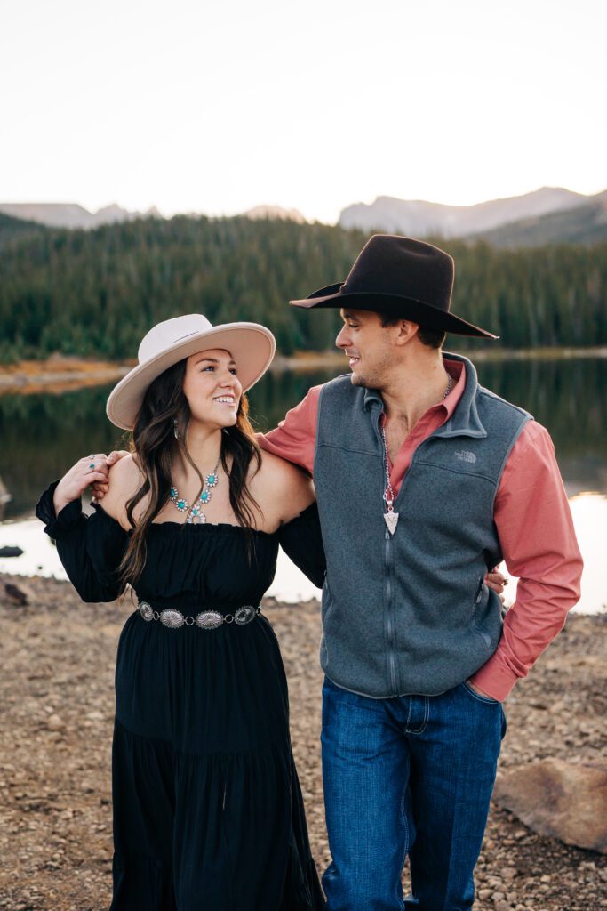 girlfriend smiling up at her fiance during their brainard lake engagement session in colorado