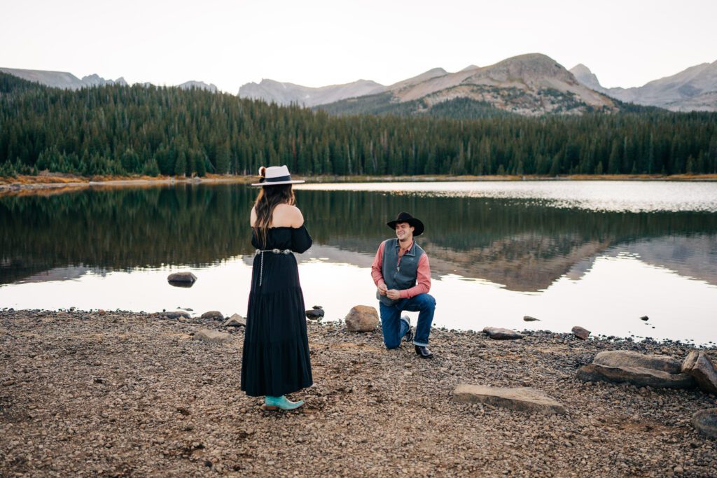 Boyfriend proposing to his girlfriend at Brainard Lake Recreation area in Colorado 