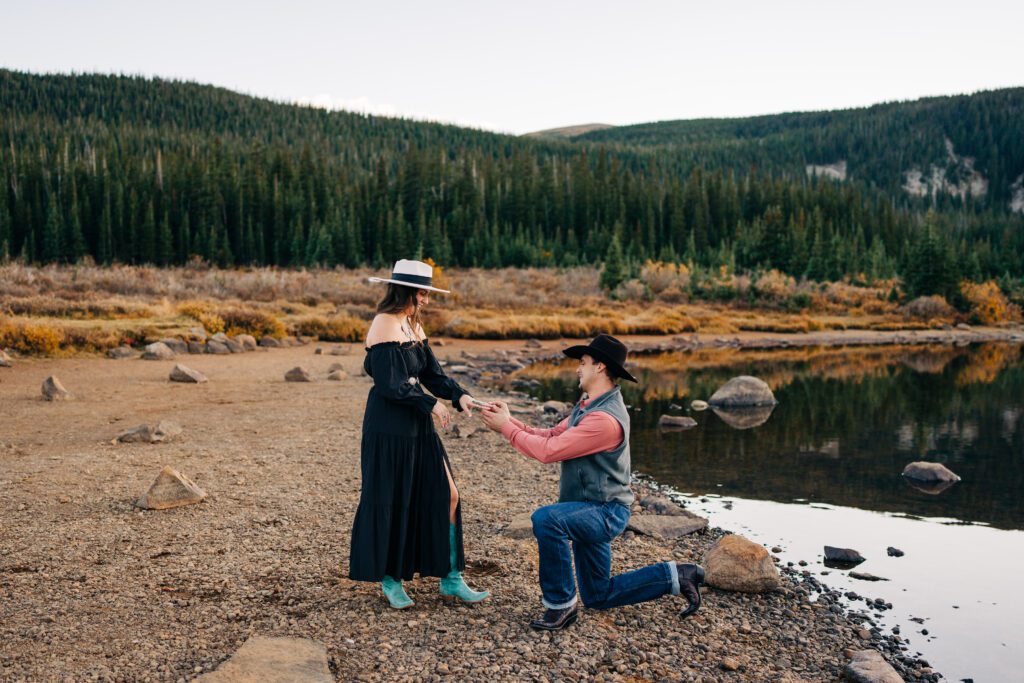 Gentleman down on one knee proposing to his girlfriend during their Brainard Lake Engagement Session in Colorado