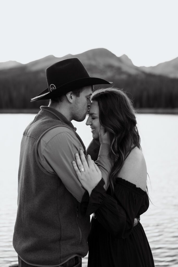 Boyfriend kissing his girlfriend on the forehead after he just got done proposing to her during their Brainard Lake Engagement Session