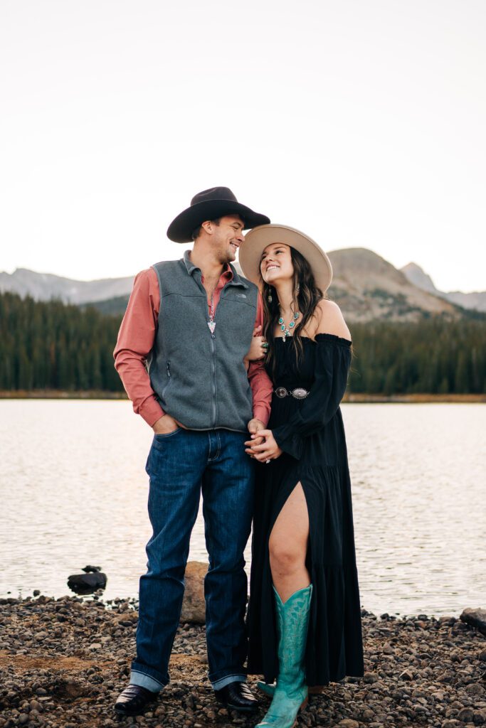 Girl smiling up at her boyfriend as they hold hands during their Brainard Lake engagement session in Colorado