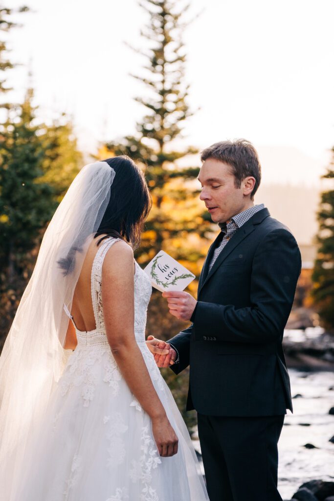 Colorado wedding couple reading their elopement vows to each other.