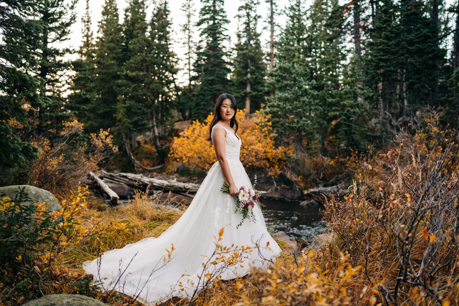 portrait of bride from the side while holding her bouquet during their brainard lake elopement near boulder colorado