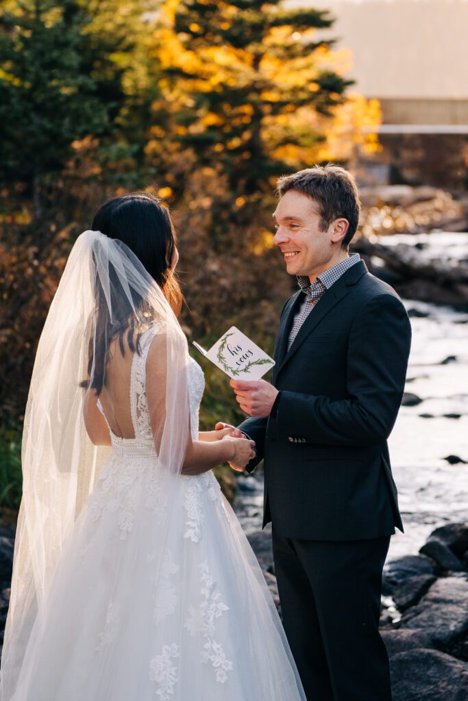 groom reading his wedding vows to his bride during their brainard lake elopement