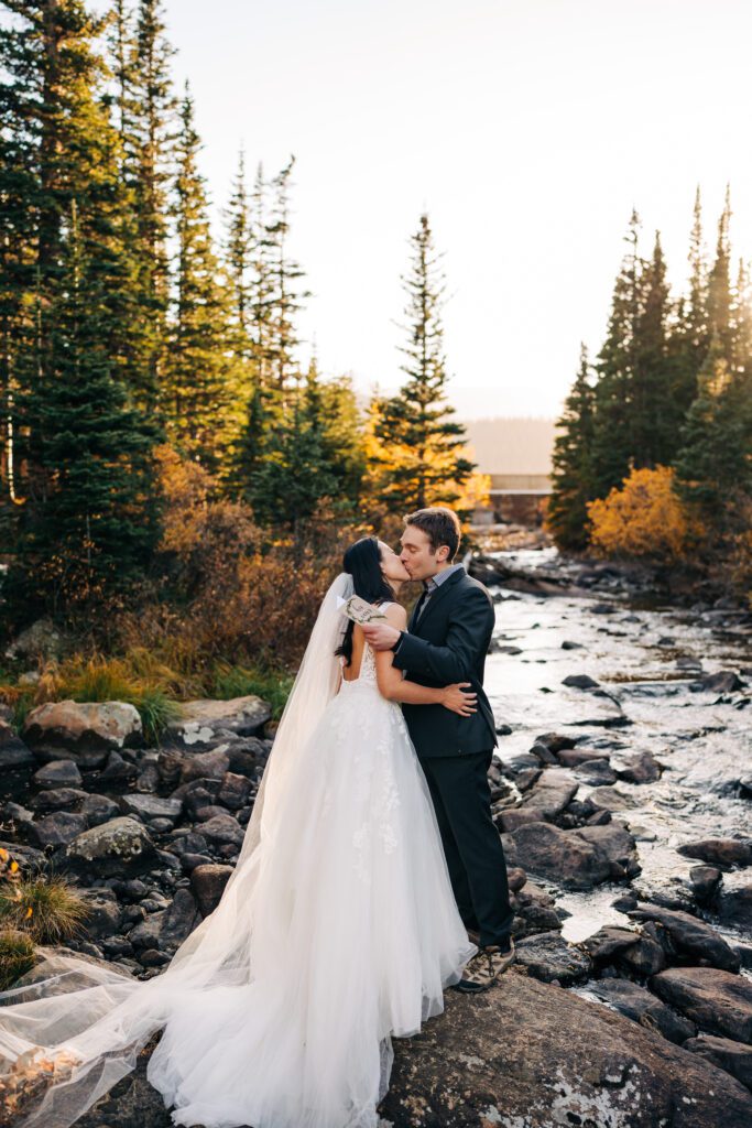 bride and groom sharing their first kiss during their sunset brainard lake elopement near boulder colorado