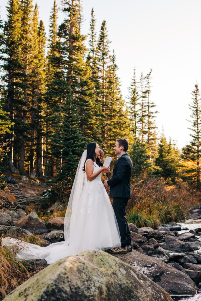 bride laughing and reading her wedding vows during their brainard lake elopement