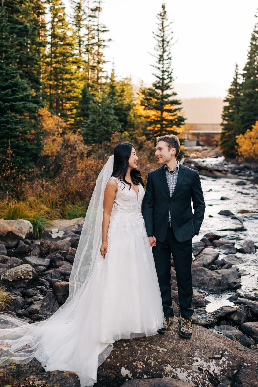 bride and groom smiling at eachother after just exchanging their rings and vows during their brainard lake elopement