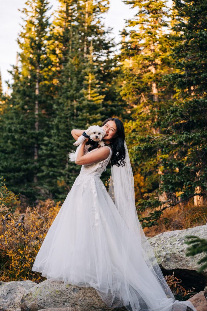 bride holding her dog during their brainard lake elopement ceremony