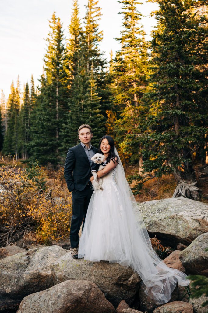 groom and bride standing with their dog after their wedding ceremony during their brainard lake elopement