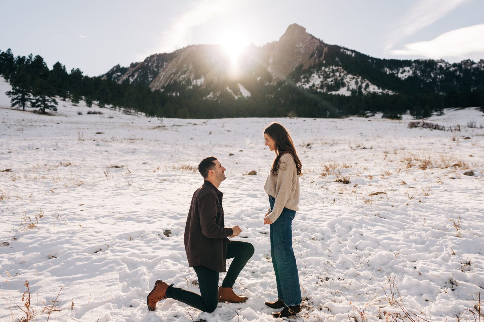 Boyfriend proposing to his girlfriend at Chautauqua Park in Boulder, Colorado during their winter engagement session.