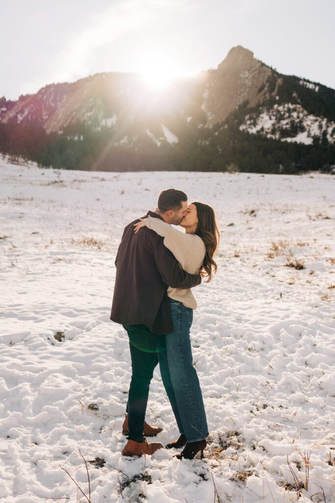 Girlfriend and boyfriend kissing after he just proposed to his girlfriend at Chautauqua Park in Boulder, Colorado during their winter engagement session