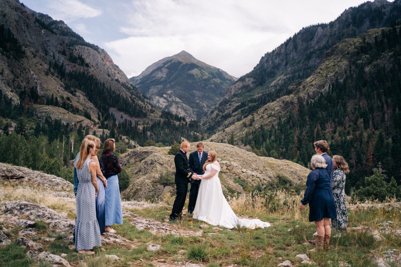 Bride and Groom holding hands in front of a mountain during their ouray elopement in colorado. 