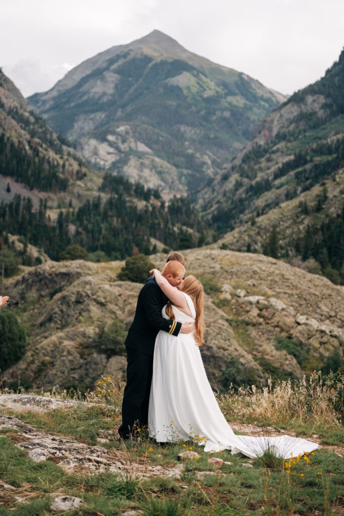 bride and grooms first kiss after their elopement ceremony in ouray colorado 