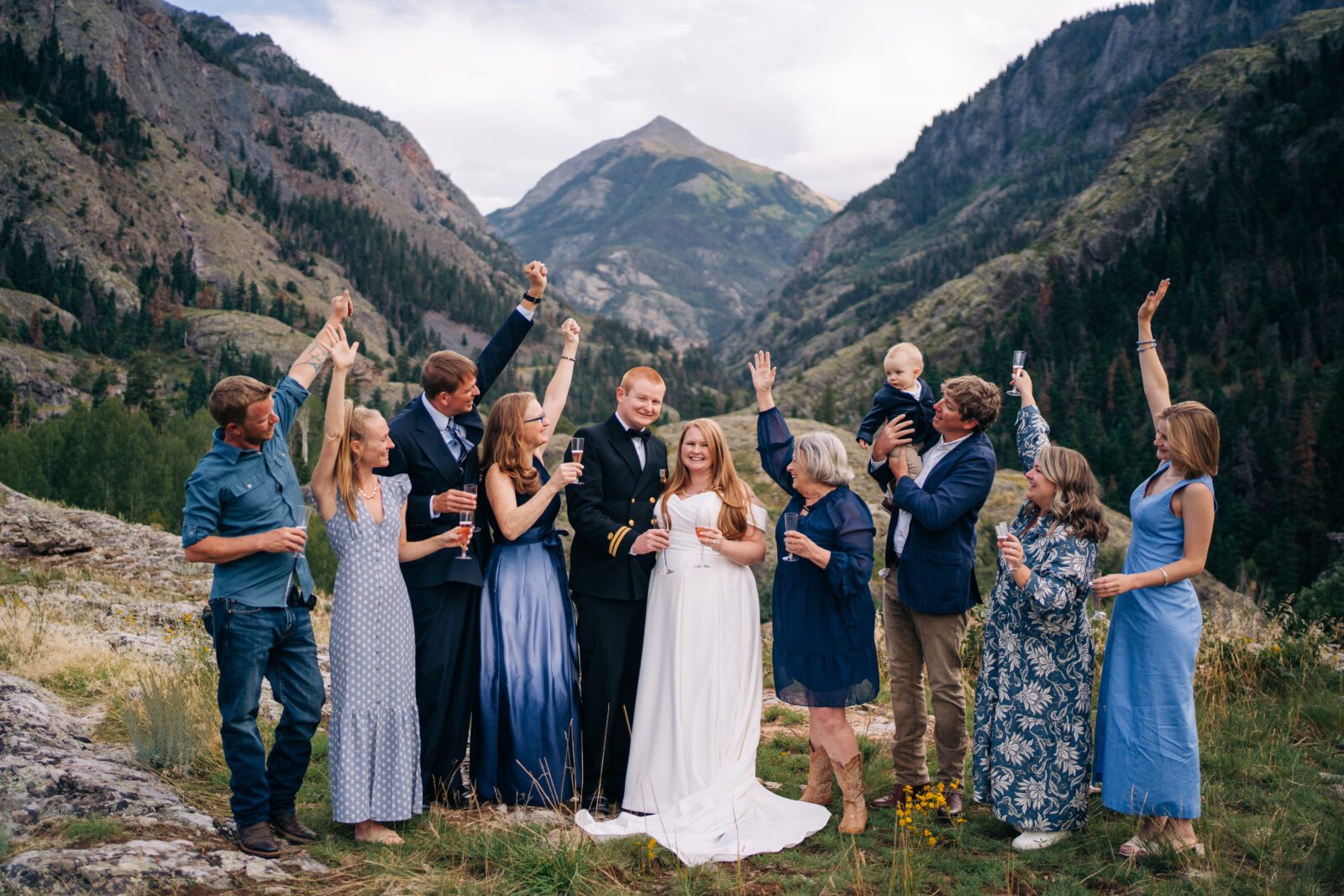 bride and groom drinking a glass of champagne with the their friends and family during their ouray elopement in colorado