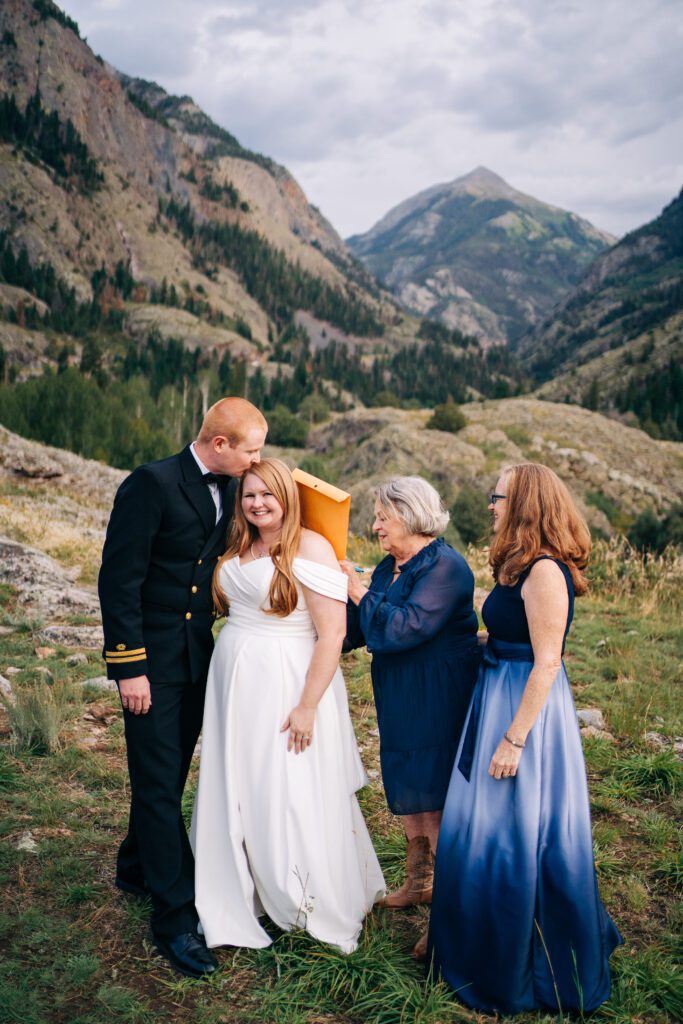 mother of the bride signing marriage license during bride and grooms ouray elopement in Colorado