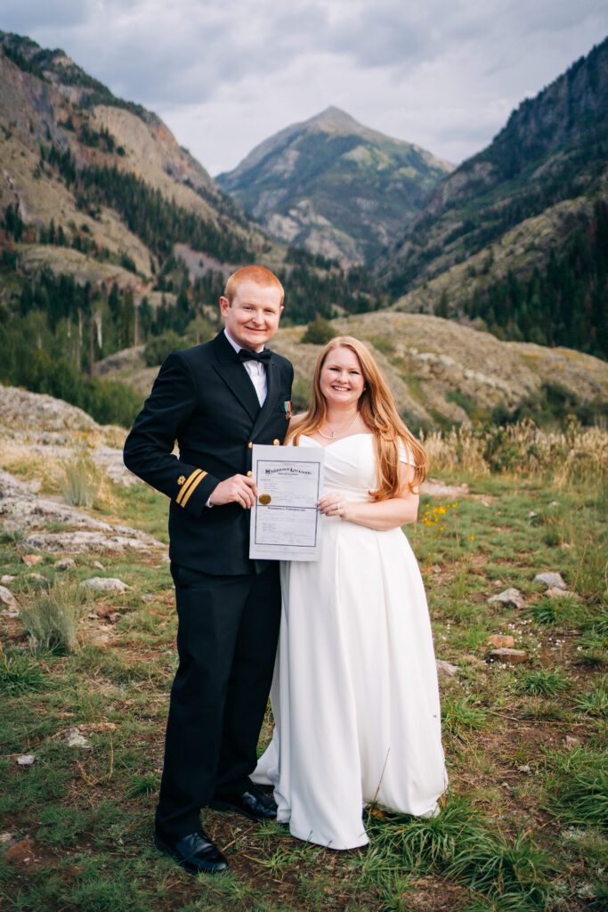 Bride and Groom holding their marriage license during their Ouray Elopement in Colorado