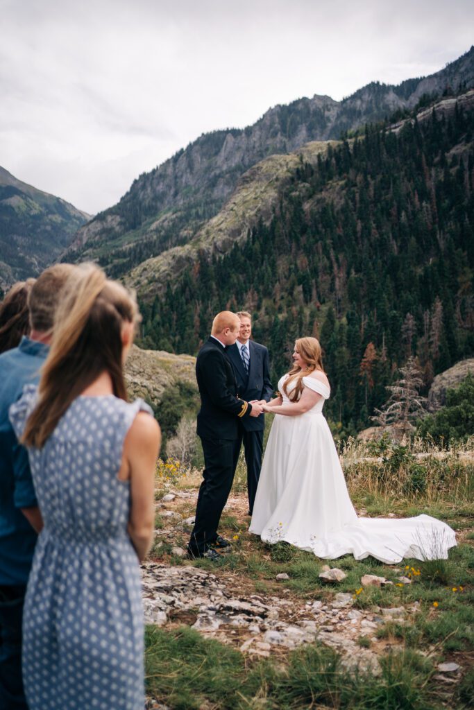 bride and groom holding hands during their ouray elopement ceremony in the mountains of colorado 