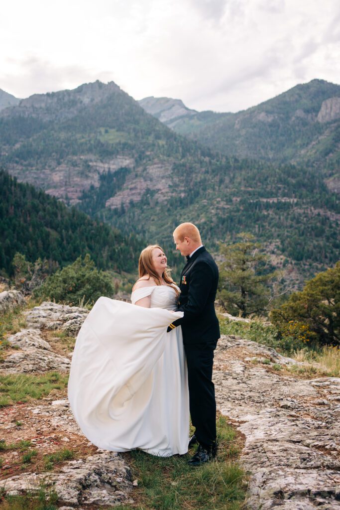 bride and groom dancing on top of a mountain during their ouray elopement in colorado