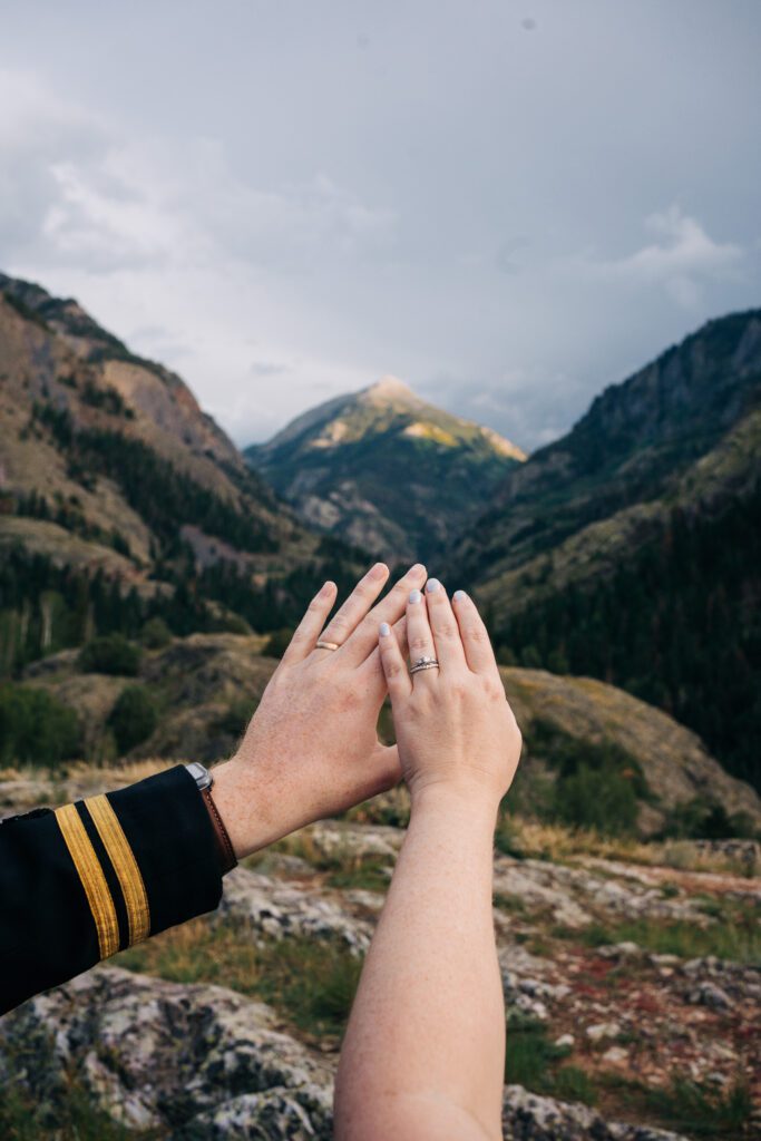 bride and groom overlapping their hands showing off their wedding rings during their ouray elopement