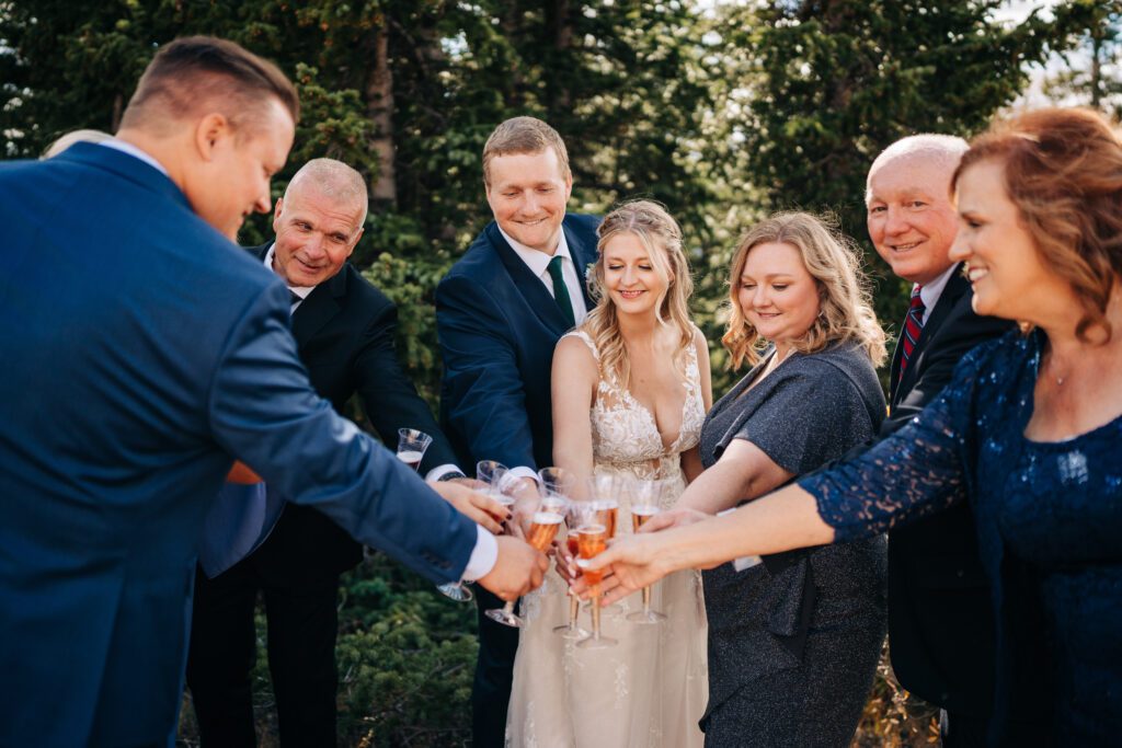 Bride and Groom toasting with champagne with their guests after their Breckenridge elopement