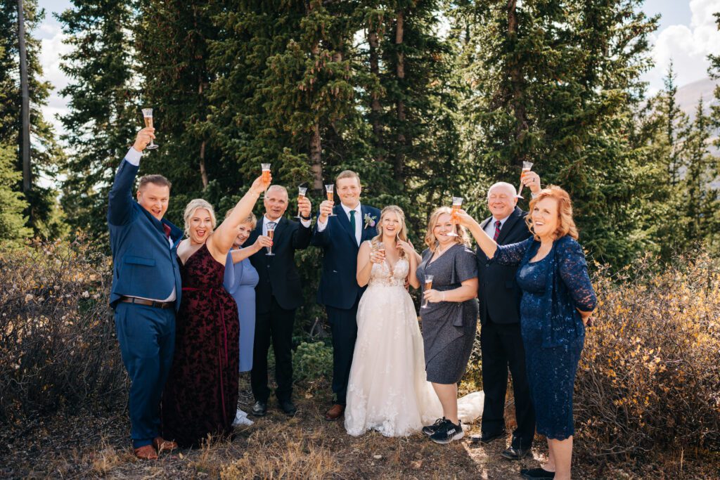 Bride and groom toasting and celebrating with champagne after their Breckenridge elopement