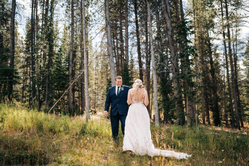 groom checking out the bride after their first look during their Breckenridge elopement