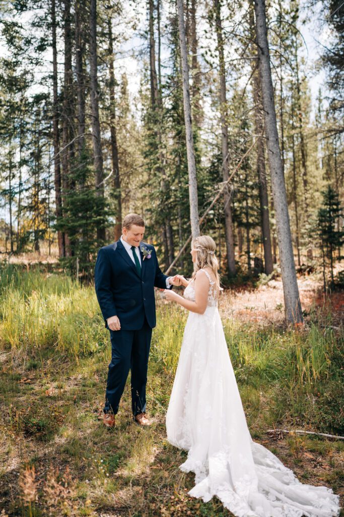 Groom checking out his bride during their first look during their Breckenridge elopement