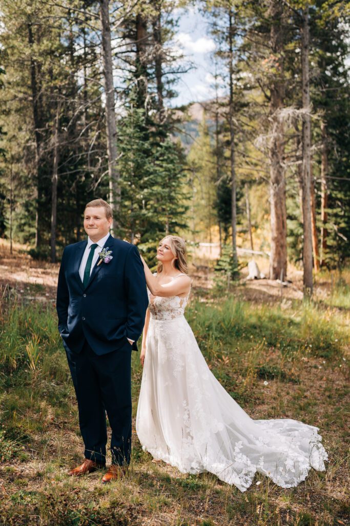 Bride tapping groom on his shoulder about to have their first look during their Breckenridge elopement