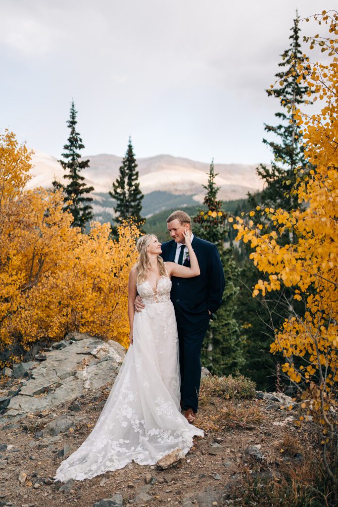 Bride and groom kissing in the forest in the mountains of Colorado during their Breckenridge elopement