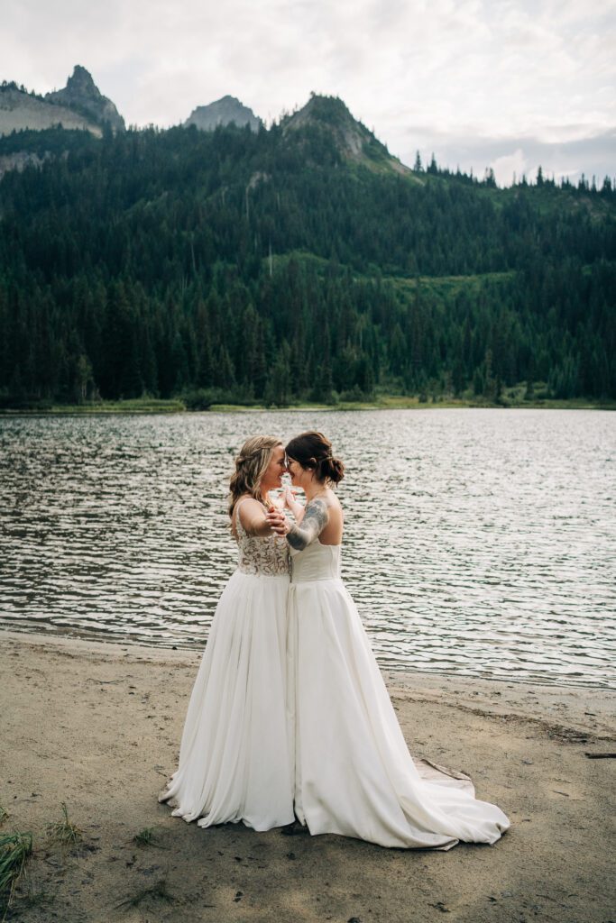 wives holding hands smiling at eachother during their washington elopement