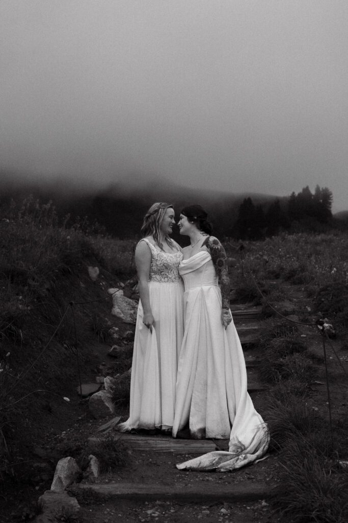 bride whispering in her wives ears during their washington elopement