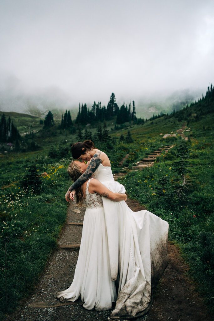 bride holding her wife up during their mt rainier national park during their washington elopement