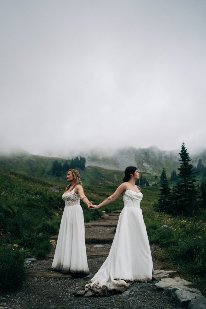 wife holding her wives hands in mt rainier national park during their washington elopement