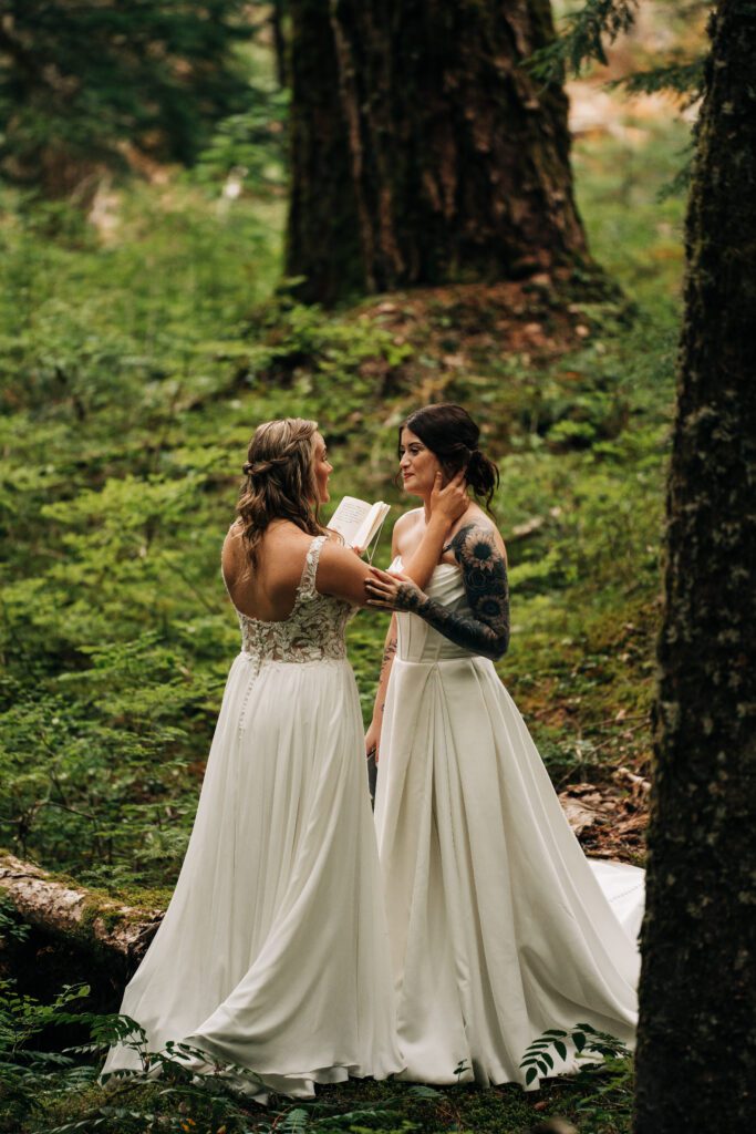 wife reading her vows during their mt rainier elopement ceremony during their washington elopement