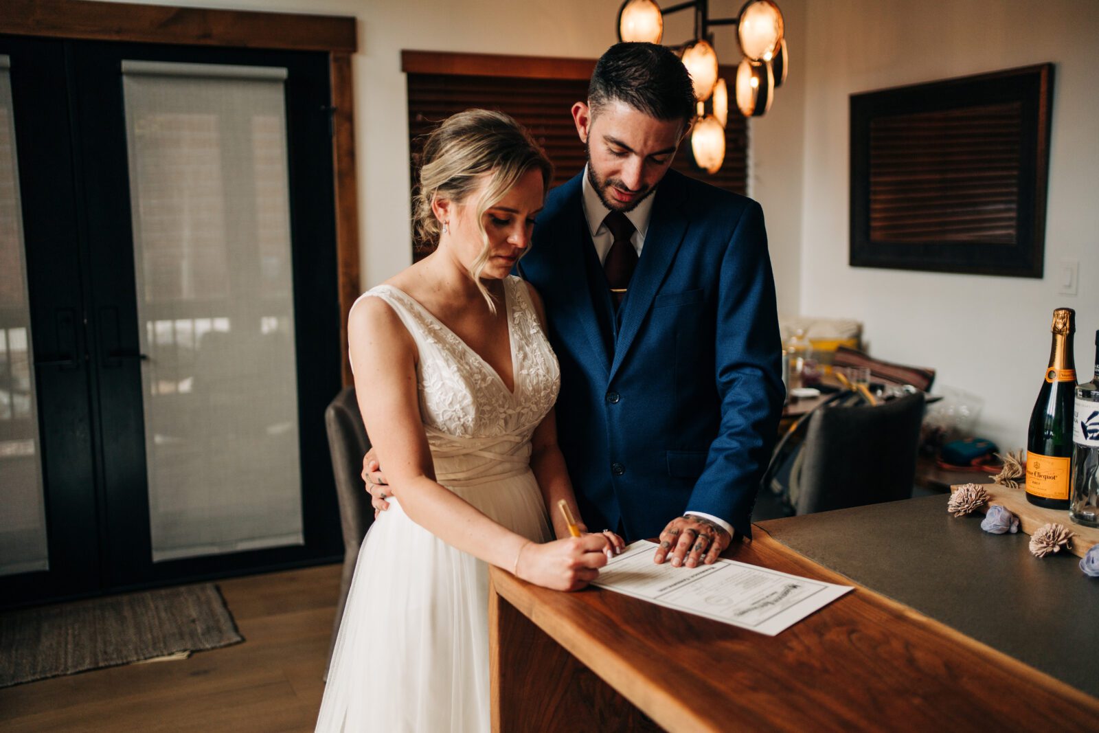 Hannah signing marriage license as Oliver watches during their Rocky Mountain National Park Elopement