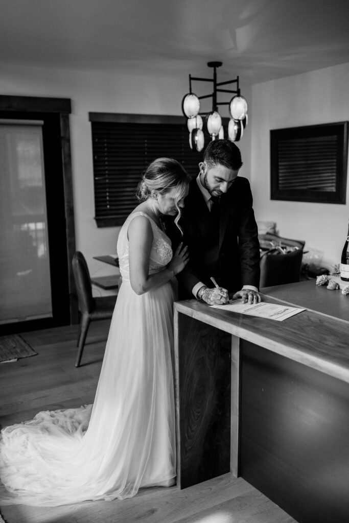 Groom signing marriage license after their rocky mountain national park elopement