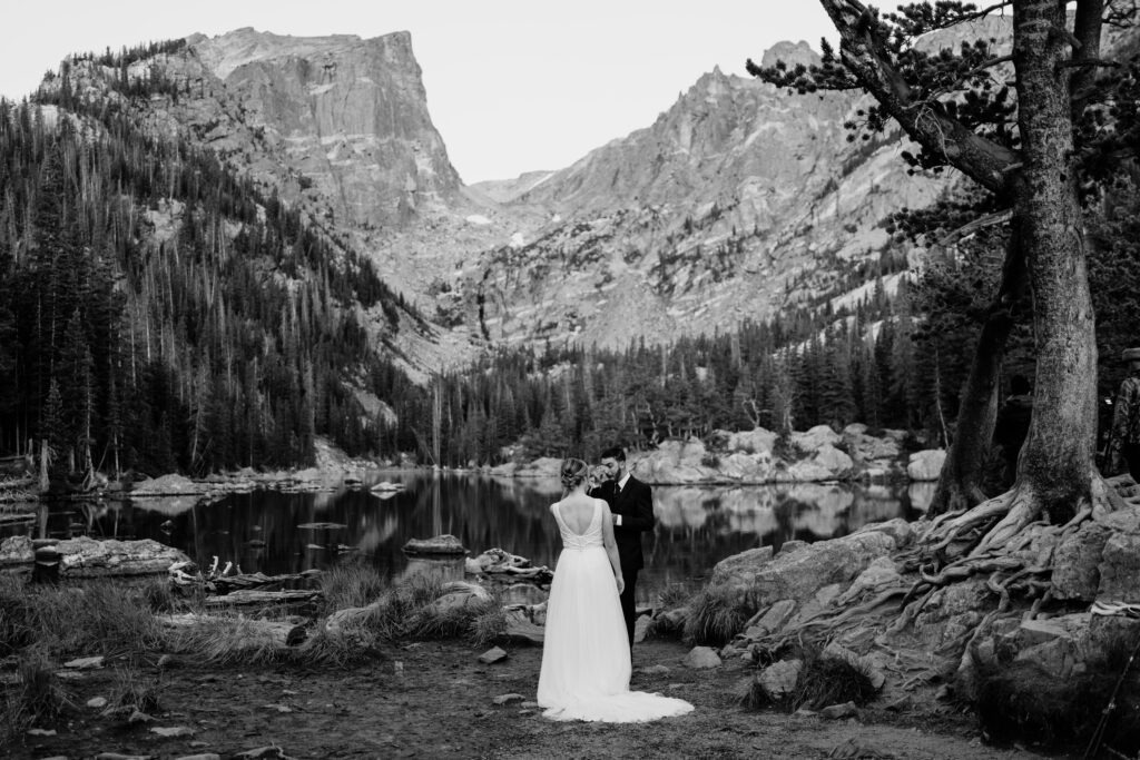 Groom crying after seeing bride for the first time at dream lake during their rocky mountain national park elopement