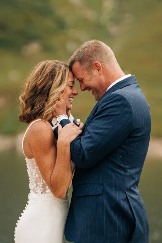 Bride and groom forehead to forehead smiling during their Telluride elopement