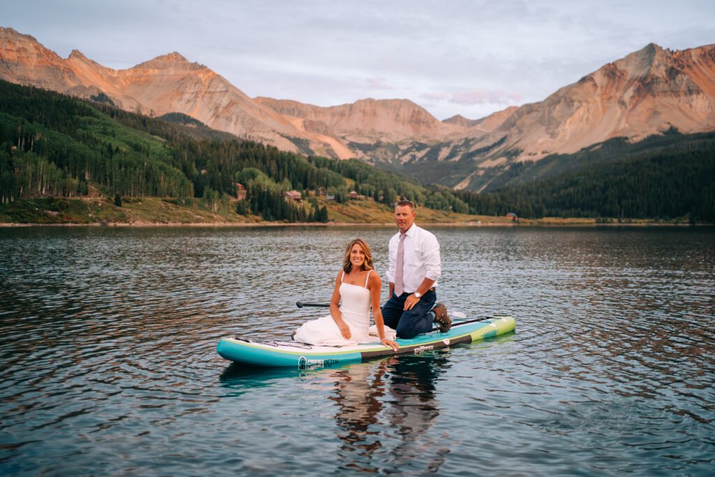 Bride and groom paddleboarding on Trout Lake during their Telluride elopement