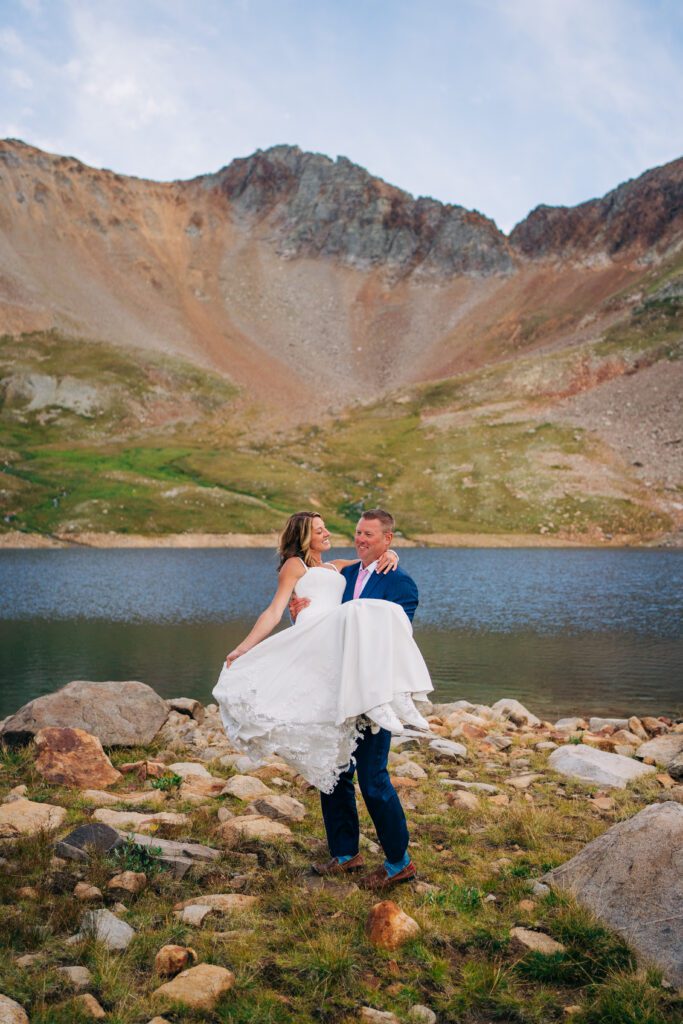 Bride picking her up and spinning her during their Telluride Elopement at an alpine lake