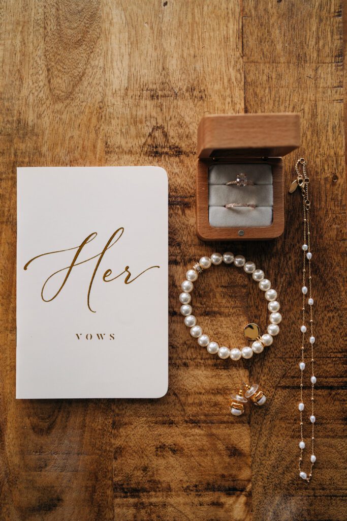 brides vow book and jewelry laid out as she preps for her Telluride elopement
