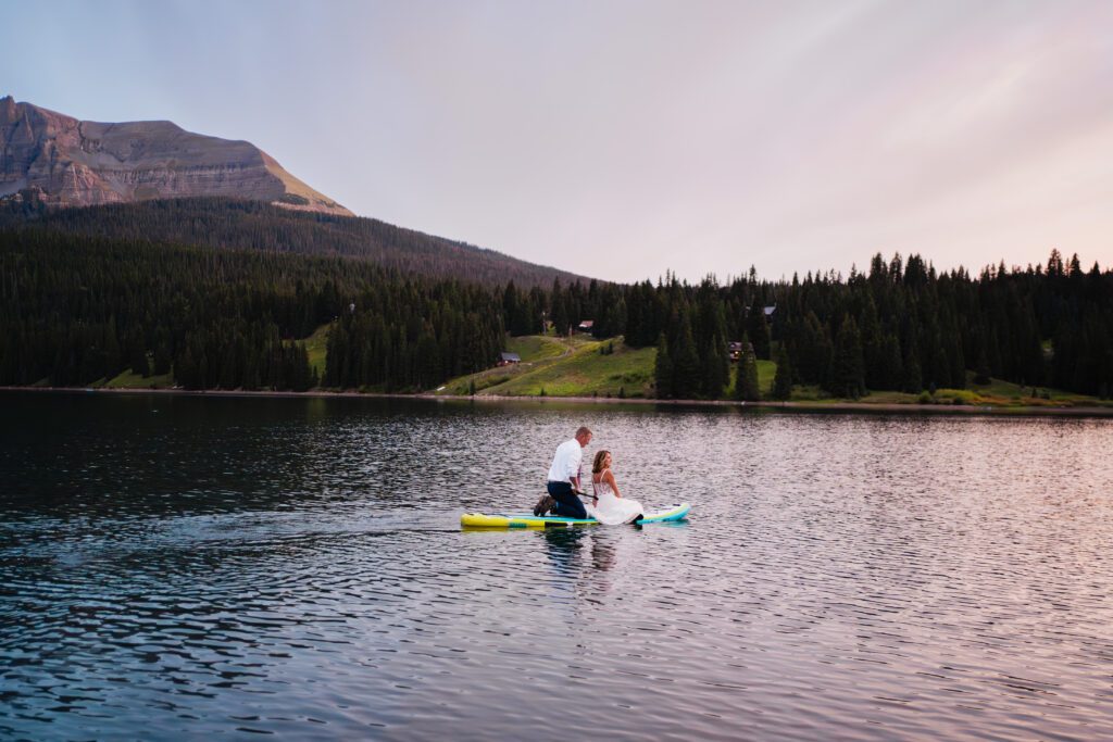 sunset photo of bride and groom paddleboarding during their Telluride elopement