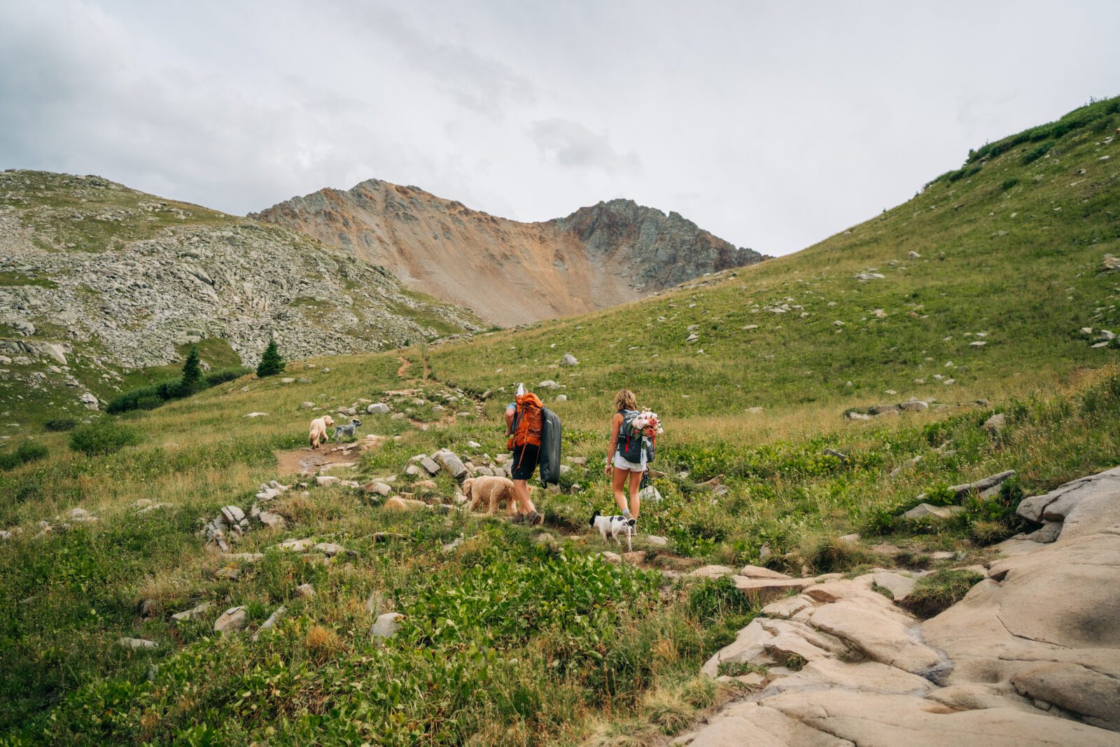  bride and groom hiking a mountain in the San Juan Mountains during their Telluride elopement